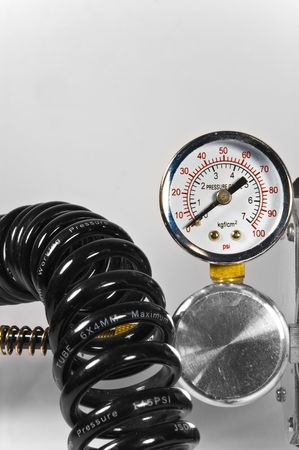 Compressor pressure gauge with black pipes on white background.の写真素材