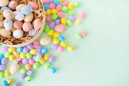 From above colorful quail eggs placed in nest made of shredded paper in pot during Easter celebrationの写真素材