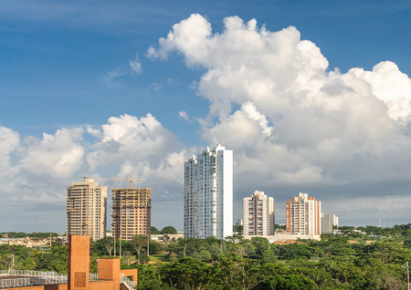 Example of green city, buildings, fresh air, many trees on a beautiful day with blue sky background.の写真素材