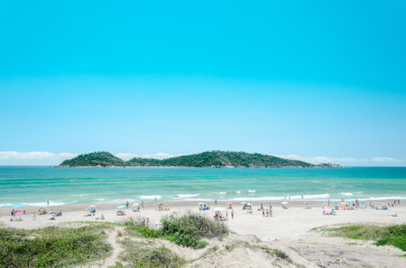 Florianopolis, SC, Brazil - December 28, 2016: People on the Campeche beach with a green water and the Campeche Island on the background on a beautiful sunny day landscape.のeditorial素材