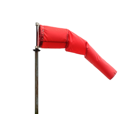 Windsock poiting the position of the wind. Red windsock isolated on white background, also known as...