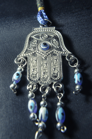 Blue Hamsa Hand, garnish object isolated on a black background.の写真素材