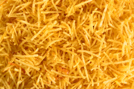 Texture of shoestring potato sticks. Fried potato, thin sticks. Also known as Batata Palha in...