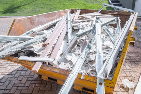 Construction garbage cart full of cement, and remains of construction.