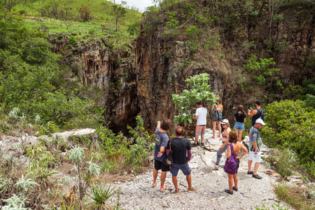CapitÃ³lio - MG, Brazil - December 08, 2020: Group of tourists observing the river down the hill at the eco tourism of Trail of the Sun. Trilha do Sol in portuguese. Landscape of the Cerrado.のeditorial素材