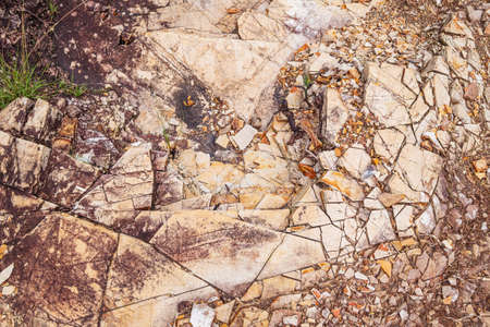 Sedimentary rock. Sedimentary rocks broken on pieces on the ground.