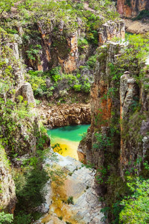 Canyons of Furnas on a sunny day, city's postcard of CapitÃ³lio MG Brazil. Landscape of eco tourism of Minas Gerais. Green water of lake and golden color of the sedimentary rocks hitted by the sun.の写真素材