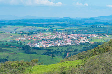 View from far away of the Brazilian Mineira city of SÃ£o Roque de Minas and rural areas around. Panoramic view of the city and farms.の写真素材