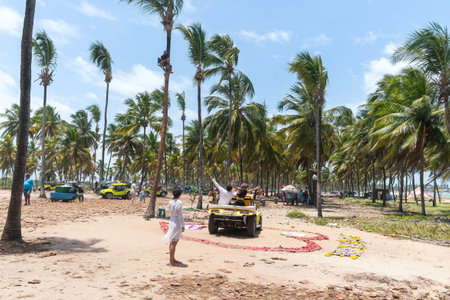 Ipojuca, PE, Brazil - October 15, 2021: tourists taking photos with the human drone during the buggy ride at the Rota dos Coqueiros. Tourist attraction of Maracaipe beach.のeditorial素材