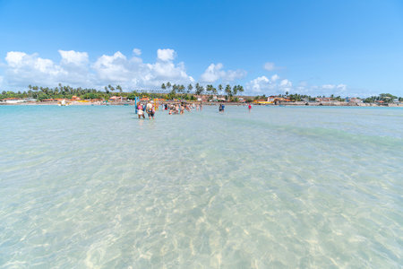Maragogi, AL, Brazil - October 17, 2021: tourists walking on Moses Path with view to Barra Grande beach. Tourist spot of Maragogi.のeditorial素材