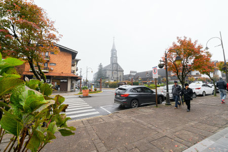 Gramado, RS, Brazil - May 19, 2022: view of Sao Pedro parish across the street, from Major Nicoletti square. Downtown of Gramado.のeditorial素材
