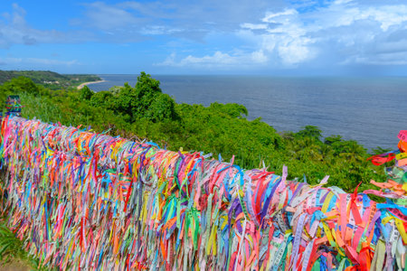 Colored ribbons tied to a fence, souvenir and tradition of those who visit Porto Seguro - Bahia, Brazil.の写真素材