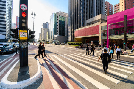 Sao Paulo, SP, Brazil - June 07, 2023: people crossing on of the crosswalks of Paulista avenue.のeditorial素材