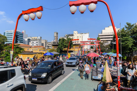 Sao Paulo, SP, Brazil - June 08, 2023: people and cars on Osaka City viaduct, oriental themed viaduct of Liberdade. Tourist destination of Liberdade.のeditorial素材