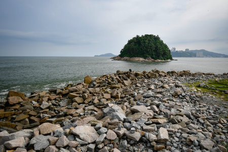 View from the rocks of the breakwater to the Urubuquecaba Island of Santos, coastal city of the interior of Sao Paulo, SP, Brazil.の写真素材