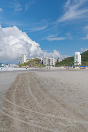 Morning at Enseada Beach on a beautiful sunny day, view of the beach sand and the sea. Guaruja - SP, Brazil.の写真素材
