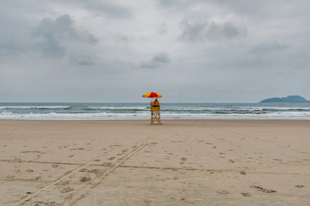 Beach lifeguard in the middle of the beach on a cloudy day and no people on the sea. Tombo beach, Guaruja - SP, Brazil.の写真素材