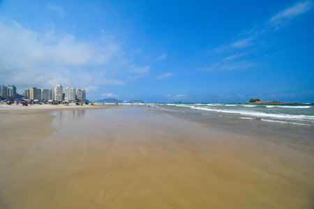 Beautiful blue sky morning at Pitangueiras beach. Beach on downtown of Guaruja, SP, Brazil.の写真素材