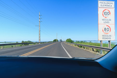 Driving the car on the Helio Serejo bridge, over the Parana river, on the BR-267 highway. Bridge that divides the states of Mato Grosso do Sul and Sao Paulo.の写真素材