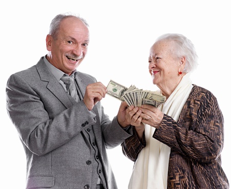 Senior man and old woman with money on white backgroundの写真素材