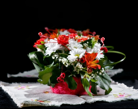 Beautiful bouquet of bright flowers in basket on a dark backgroundの写真素材