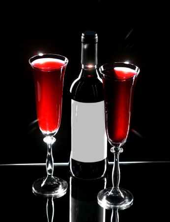 Bottle of wine and two wine glasses on a dark background の写真素材
