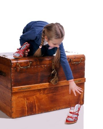 Beautiful girl reaching moms shoes on a white backgroundの写真素材