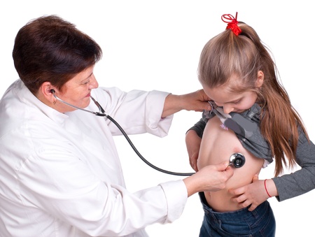 Senior doctor listening girl with stethoscope on a white backgroundの写真素材