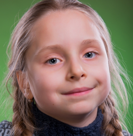 Close-up portrait of pretty girl on a greean backgroundの写真素材