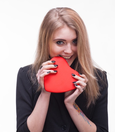 Young blond tasting heart on a white backgroundの写真素材