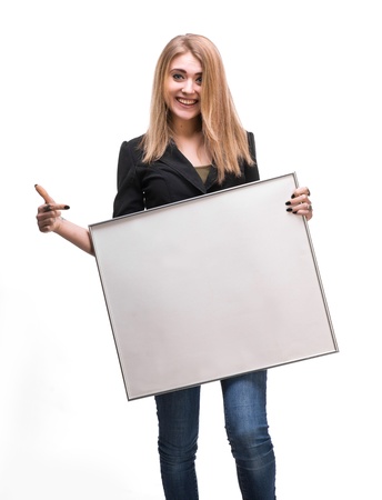 Portrait of a young blond holding empty billboard on a white backgroundの写真素材