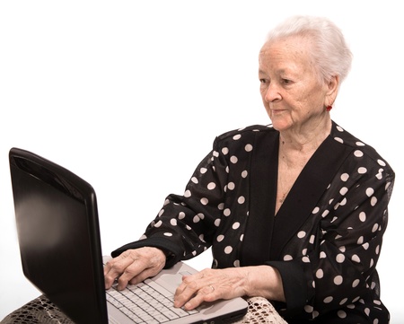 Old woman  working on computer  on a white background