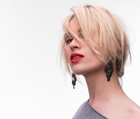 Portrait of young beautiful blond girl with red lipstick on a white backgroundの写真素材