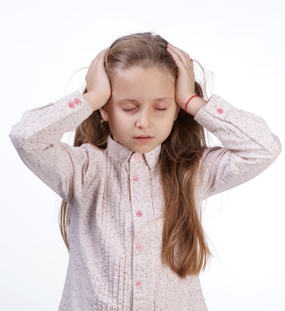 Little girl suffering from headache on a white backgroundの写真素材