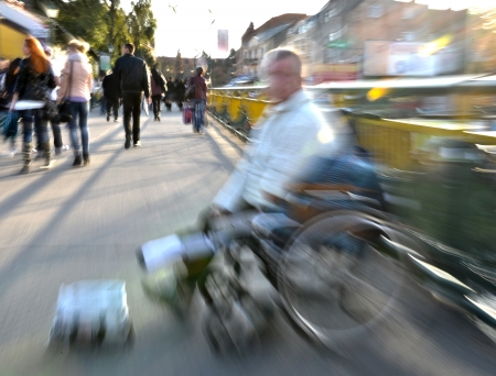 Beggar in wheelchair in motion blurの写真素材