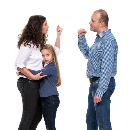 Sad looking girl with her fighting parents on a white backgroundの写真素材