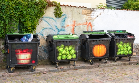 Four colorful trash cans in the street