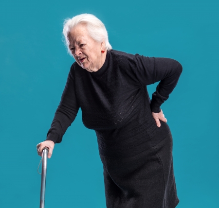 Old woman holding her lower back  Low back painの写真素材