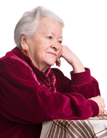 Thoughtful old woman on a white の写真素材