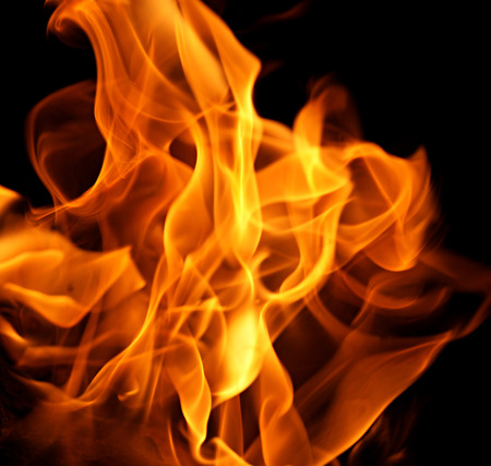 Orange fire flames on a black backgroundの写真素材