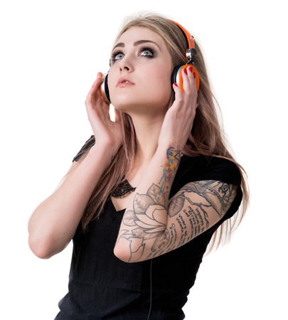 Smiling young girl in headphones on a white backgroundの写真素材