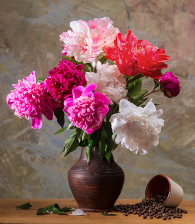 Artistic still life with peonies and cup of coffee beansの写真素材