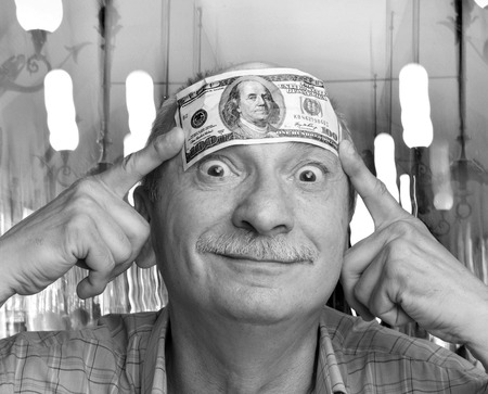 Man with one dollar bill on the forehead