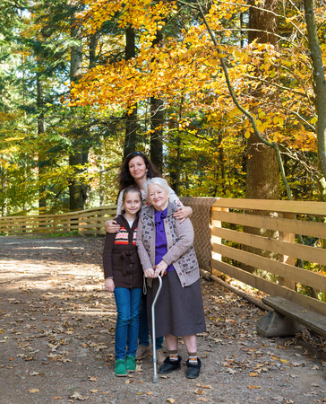 A multi generation portrait of a happy grandmother with her daughter and granddaughter outdoor