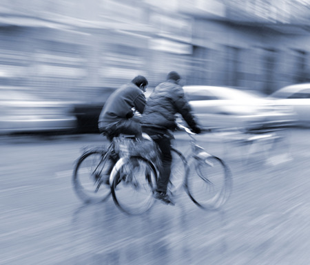 Two cyclists on the city roadway in motion blur