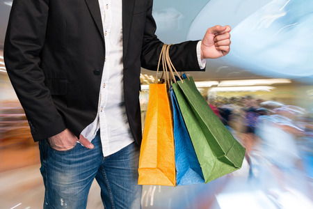 Man with shopping bags at shopping mallの写真素材