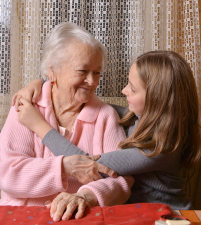 Portrait of grandmother and granddaughter at homeの写真素材