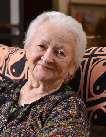 Portrait of smiling old woman at homeの写真素材