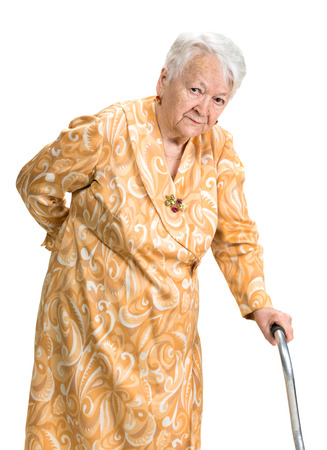 Old woman suffering from low back pain on a white backgroundの写真素材