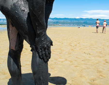 Man applying black healing clayの写真素材